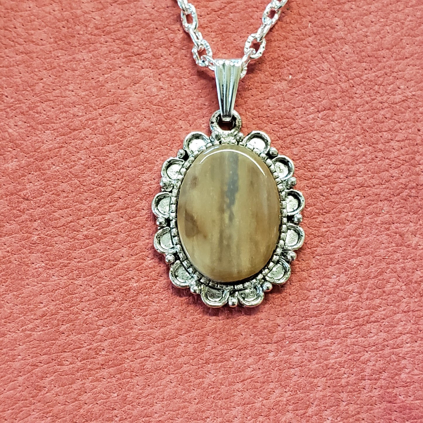 This tiny delicate necklace has been handcrafted from Alaskan Fossil Mammoth Ivory that is approximately 25,000 years old. All the unique coloring seen in this piece are colors absorbed from the minerals that the Mammoth Ivory Tusk has lain in. This neck