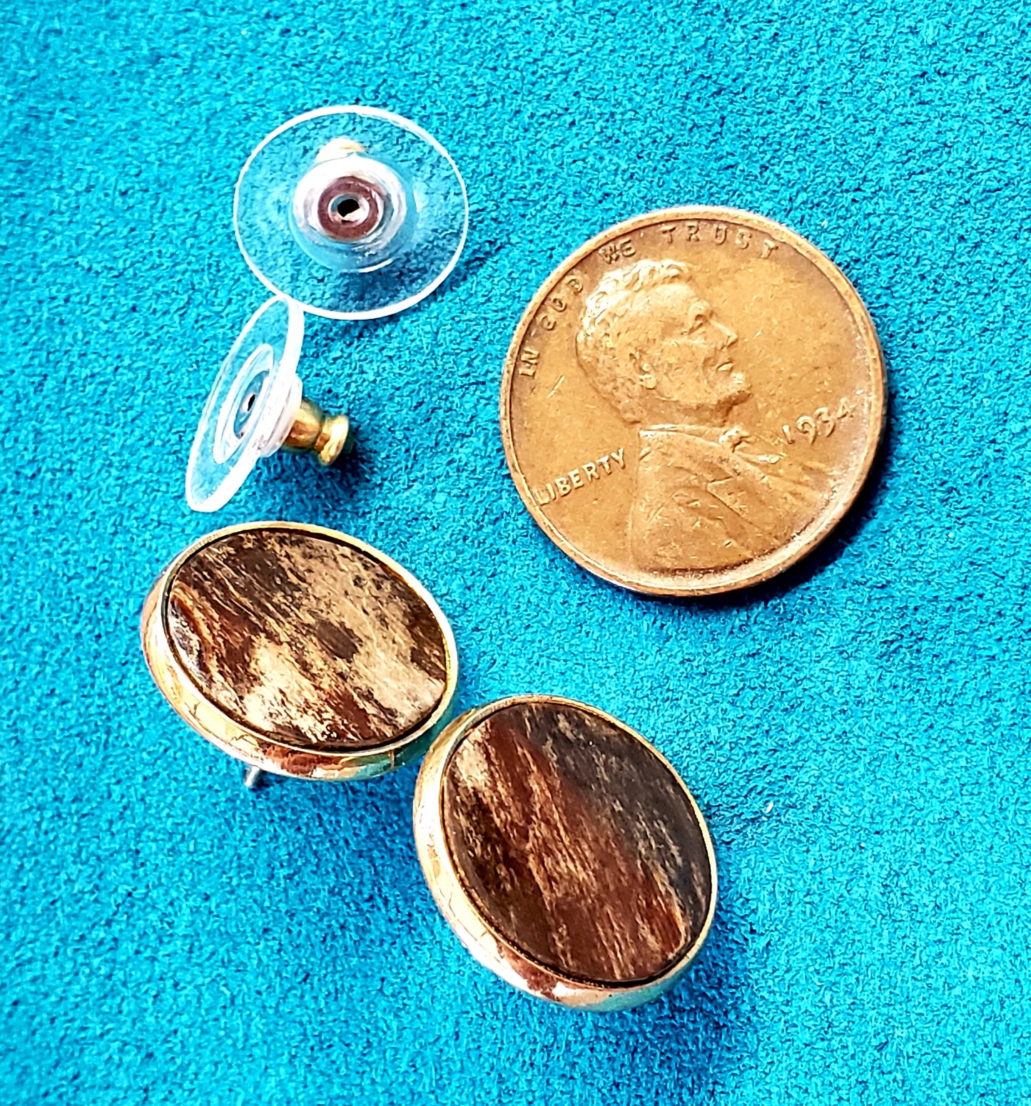 This pair of Fossil Mastodon Ivory Post Earrings is estimated to be well over 300,000 years in age. The color is from minerals that are absorbed from the soil in Alaska were the Ivory was unearthed.