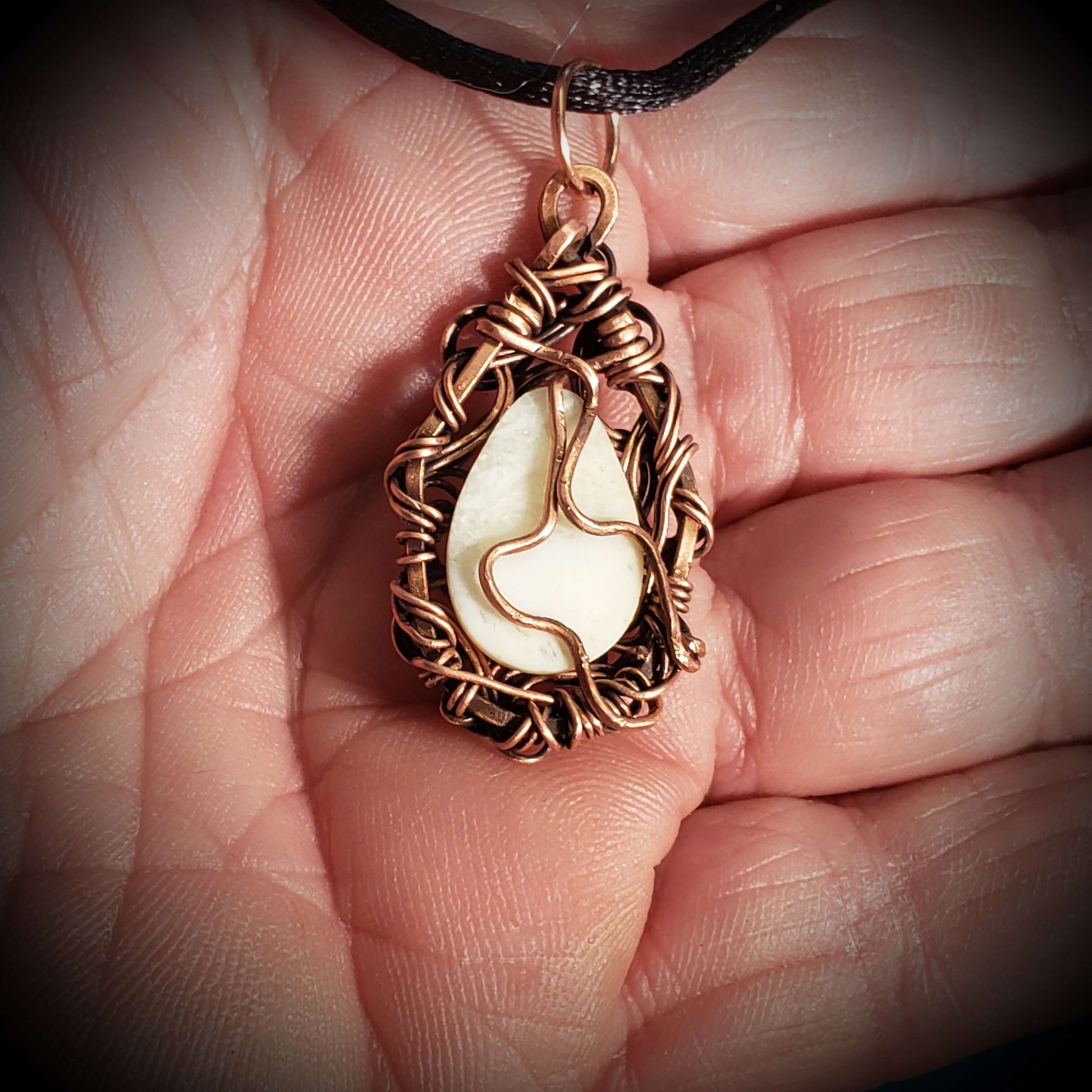 The back of a Copper Wire Wrapped Fossil Walrus Ivory Necklace