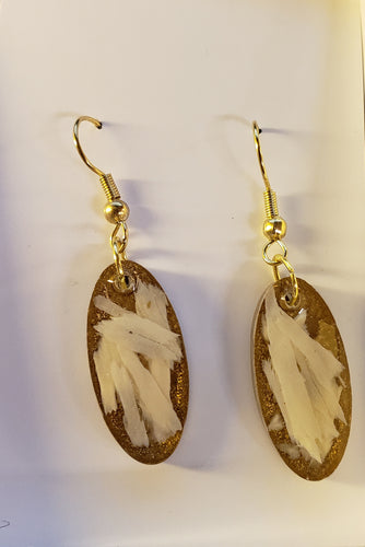 This pair of Fossil Mammoth Ivory earrings are unique. They were an experiment that I think turned out stunning.   Many of the piece of Fossil Mammoth Ivory I find are so degraded that I will not use them, which seems a total waste of such a wonderful resource.   That being the case with these paper thin shards of Alaskan Fossil Mammoth Ivory. I have discovered a way to utilize and preserve the fragile beauty of these 10,000 year old remnants, set in clear resin. 1