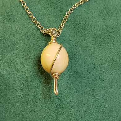 This Fossil Ivory Bead was crafted in the mid 1950 by an unknown artist in Alaska. It is wire wrapped in Sterling Silver and hung on a Sterling Silver 22