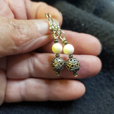 This pair of Fossil Mammoth Ivory Bead Earrings are about 10,000 years old and the Ivory is from Alaska.  

This pair is kind of heavy as the silver beads are solid. 1