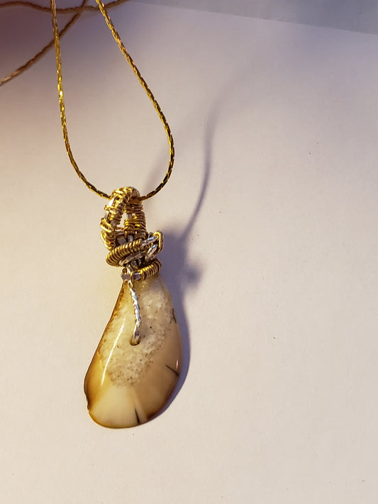 This 1.25" x .75" Fossil Walrus Ivory Pendant is many thousands of years old. It was found in Alaska on the Bering Sea coast. Hung on a 22" 18Kplt Gold Chain. Wire Wrapping by Tina of Mammoth Ivory Creations Studio 