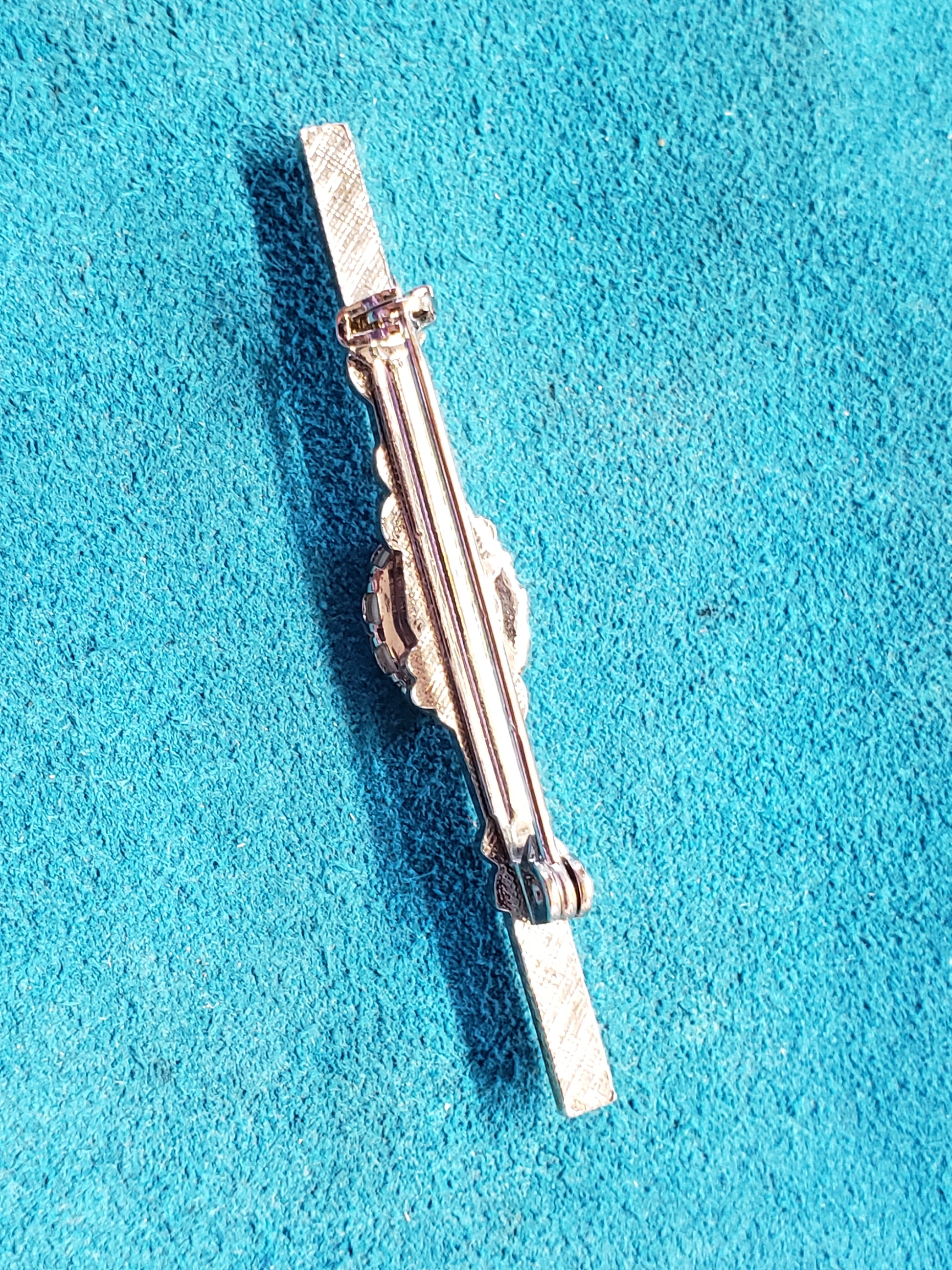 This 2" Scrimshawed Brooch could also be used as a tie tack. It has been crafted from silver and Fossil Mammoth Ivory. Artist unknown. 2"× .50"